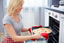Happy woman baking pizza
